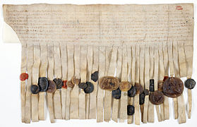 Charte par laquelle Henri III d'Angleterre et ses barons prennent Louis IX comme arbitre de leurs différends, scellée de 25 sceaux appendus sur queues de parchemin, 1263. Archives nationales AE-III-64.