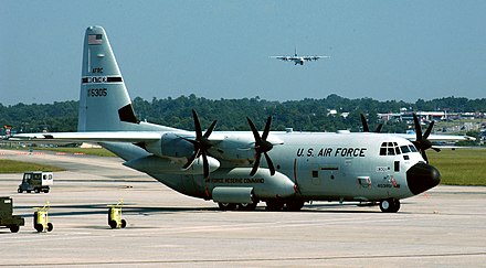 WC-130J Hercules on the ramp at Dobbins ARB, Georgia, with another landing behind it, during reployment for Hurricane Katrina. Lockheed Martin WC-130J.jpg