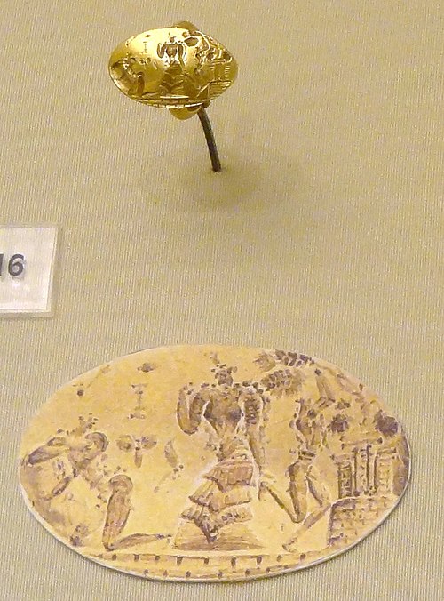 Gold Minoan seal ring, with drawing of design. The goddess in the centre appears to the figure at left, lying on a stone. The worshipper at right is s