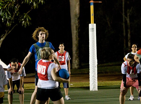 Men and women play together during a mixed netball game in Australia.