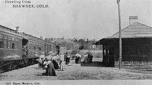 Postcard depicting people boarding a train at the Shawnee Depot in Colorado, late 1800s.