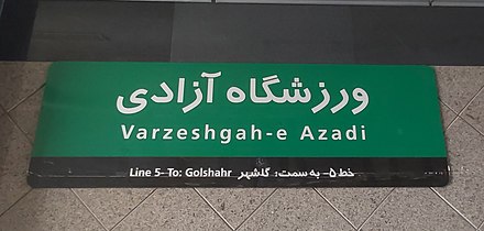 A sign shows the name of a stationwith both Latin and Perso-Arabic scripts at Varzeshgah-e Azadi Metro Station.