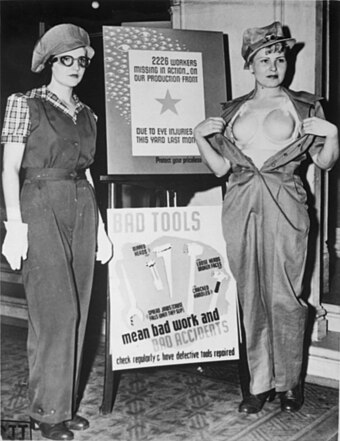Two women show off a new uniform—including a plastic 'bra'—designed to help prevent occupational accidents among female war workers in Los Angeles in 1943.