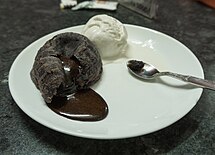 A chocolate soufflé with lava centre served with ice cream