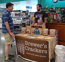 A product demonstration of crackers made from spent grain at a local supermarket. Spent Grain Cracker Demo.jpg