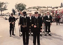 Lt. Commander John Edwards, RNR (SCC), two other officers, and the Guard of TS Admiral Somers parade at Ordnance Island, Bermuda for the completion of Dodge Morgan's record-breaking circumnavigation of the world aboard the American Promise on 11 April 1986. TS Admiral Somers Guard.jpg