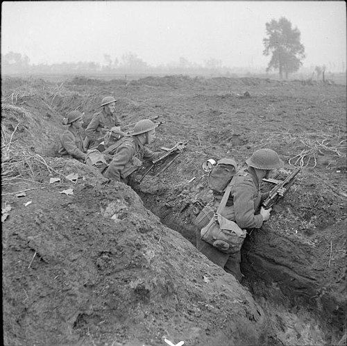 Infantrymen of the 1/5th Battalion, Queen's Royal Regiment occupy a captured German trench at Laar during the drive on Hertogenbosch, Holland, 24 Octo