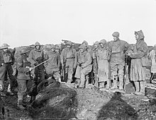 Men of the York and Lancaster Regiment receiving instructions in the trenches before starting out on a patrol near Roclincourt, France, 12 January 1918. Note their camouflaged outfits. The British Army on the Western Front, 1914-1918 Q23580.jpg