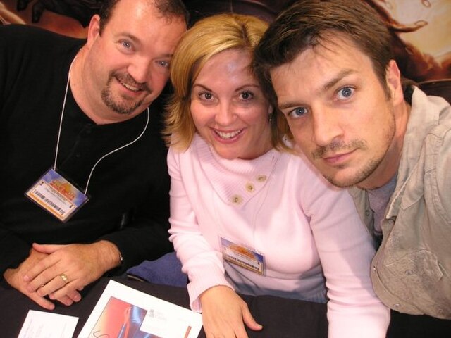 Hickman with husband Tracy Hickman (left) and Nathan Fillion (right)