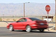 A car driving past a stop sign without stopping, a common form of moving violation USMC-03597.jpg