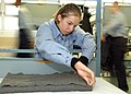US Navy 021105-N-5576W-001 Seaman ensures her blanket is folded and presented the proper way in a practice bunk and locker inspection.jpg