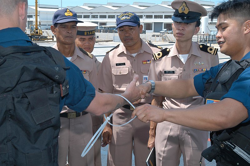 File:US Navy 030609-N-5564G-004 Hospital Corpsman 2nd Class Brandon Dela Cruz demonstrates the proper use of restraints on Gunner's Mate 2nd Class John Barkmeyer during a visit board search and seizure (VBSS) demonstration.jpg
