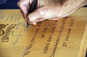 US Navy 091218-N-7498L-308 Capt. Jerome Hamel, commander of Sealift Logistics Command Pacific, signs his name as a witness to the decommissioning ceremony of the Military Sealift Command combat stores ship USNS San Jose.jpg