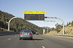 A full matrix walk-in cabinet LED sign (manufactured by Skyline Products) displaying travel times on Interstate 70 north of Evergreen, Colorado.