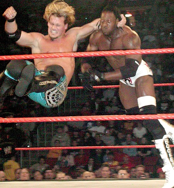 Chris Jericho performing a one-handed bulldog on Booker T.