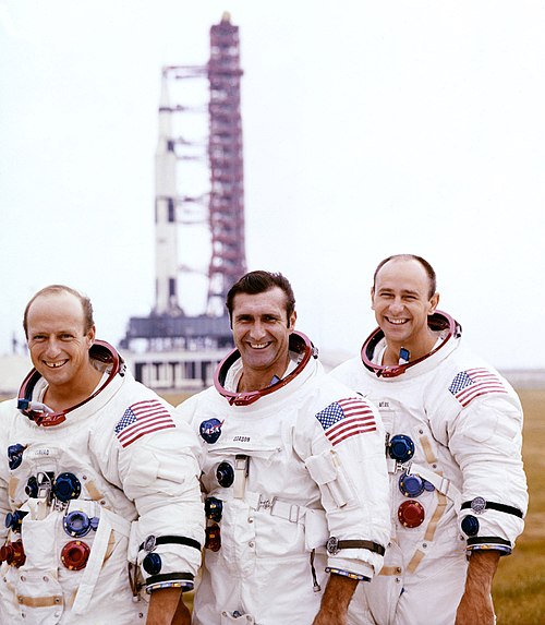 Pete Conrad, Dick Gordon, and Alan Bean pose with their Apollo 12 Saturn V Moon rocket in the background on the pad at Cape Canaveral on October 29, 1