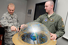 Trainer using a celestial sphere to show student a point used to see the apparent path the sun takes through the stars. 533d Training Squadron - Training.jpg