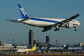 ANA Boeing777-346ER is landing beside of Vanilla Air Airbus A320 at Tokyo Narita Airport.