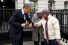 Barack Obama bumps elbows with women in the street.jpg