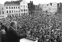 Brandt giving a speech in Wismar, campaigning for the only free parliamentary election in East Germany (March 1990) (Source: Wikimedia)