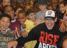 John Cena, seen here with child fans, was the face of the company during the PG Era, despite being unpopular with some older fans CENATION2-T4.jpg