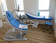Chair for gynaecological examinations. Next to the chair a sonography device and screen. Chair for gynaecological examination.jpg