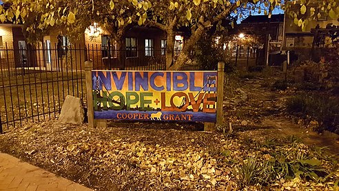 A community sign near Camden's Cooper Grant neighborhood showcasing the city's official tagline "A City Invincible"