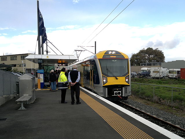 An EMU arrives at Onehunga Railway Station on its first day of public service
