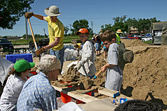 Sandbags being filled using improvised methods, lumber and traffic cones as chutes, Iowa City, Iowa, 2008.