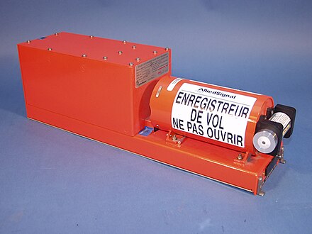 A modern flight data recorder; the underwater locator beacon is the small cylinder on the far right. (Translation of warning message in French: "Flight recorder do not open".)  The warning appears in English on the other side.