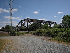 The trail then reverts to gravel and breaks to the left to get around this rail bridge...