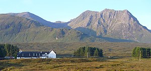 The northern cliffs of Creise tower behind the Kings House Hotel.