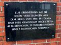 Plaque on the wall of the cemetery for soldiers buried here began the War of 1866