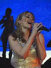 Minogue performing the song on her Aphrodite: Les Folies Tour (2011). Kylie Minogue I Believe In You Aphrodite Les Folies tour.jpg