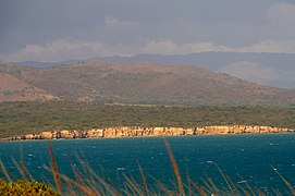 Reddish-colored limestone cliffs.