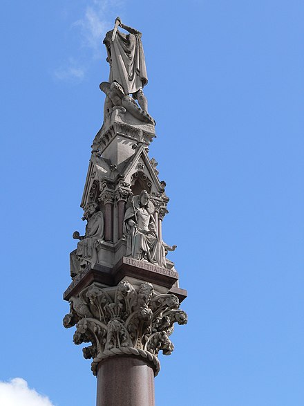 Detail of the floral capital, statues of Henry III and Elizabeth I, and the rear of St George and the dragon