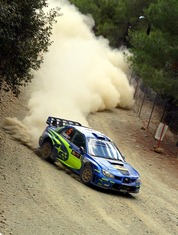 Petter Solberg driving a Subaru Impreza WRC on gravel at the 2006 Cyprus Rally, a World Rally Championship event