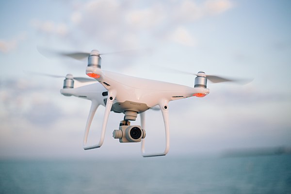 A DJI Phantom quadcopter drone in flight