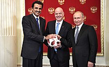 Russian President Vladimir Putin handing over the symbolic relay baton for the hosting rights of the 2022 FIFA World Cup to Qatar's Emir Tamim bin Hamad Al Thani in June 2018 Rusia entrego el relevo de la antorcha de la Copa del Mundo a Qatar.jpg