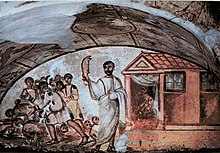 A fresco depicting a bearded man threatening a group of men with jawbone