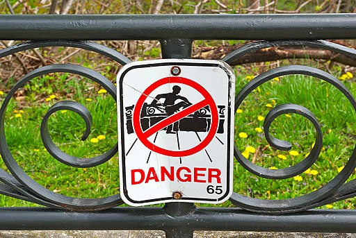 Sign in Niagara Falls, Ontario, warning people not to climb over guard rail