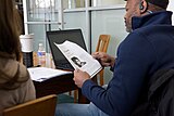 Researchers examining print materials during the Cornell University 2017 Art + Feminism Wikipedia edit-a-thon. Fine Arts Library, March 11, 2017.