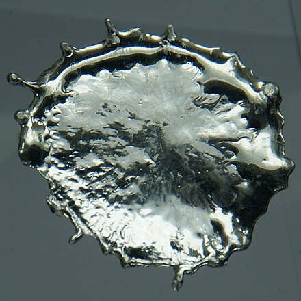 Droplet of solidified molten tin