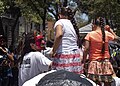 Two girls talking to a demon in the "Quema de San Judas" festival, Mexico City