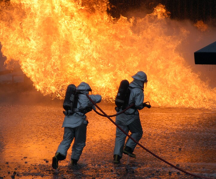 File:US Navy 041028-N-3843W-071 Two Aviation Boatswain's Mate students make an assault on a large-scale mock aircraft fire on board Goodfellow Air Force Base, Texas.jpg