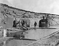 A Guthrie & Company equipment draining water from ravine near railroad tracks, circa 1914-1915 (TRANSPORT 1214).jpg