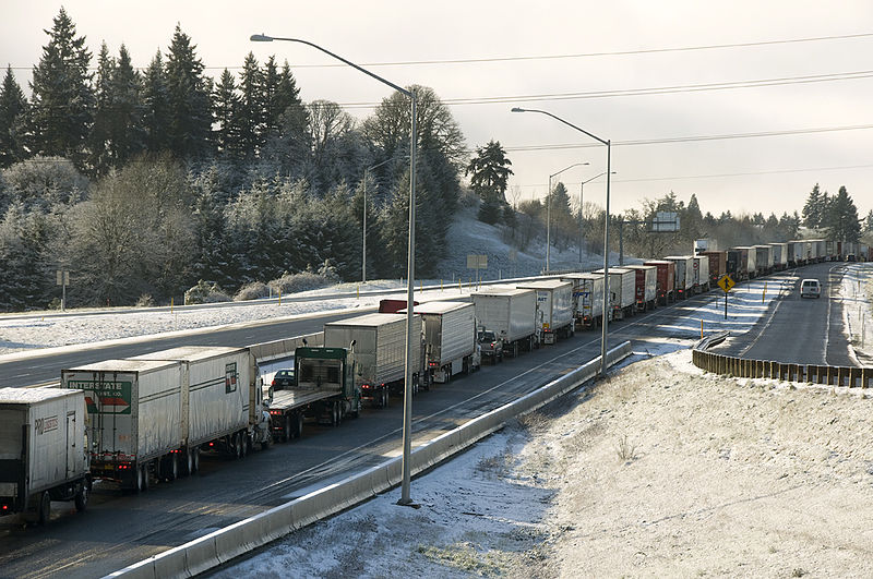 File:A line of trucks waits for a crash to clear (5495543382).jpg
