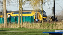 The rear carriage of the passenger train and the destroyed road-rail crane operated by Royal BAM Group AccidentTrainVoorschoten2023-6 (cropped).jpg