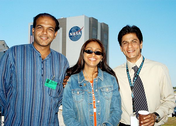 Ashutosh Gowariker, his wife Sunita and actor Shahrukh Khan pose for a photo with the Vehicle Assembly Building, Kennedy Space Center in the backgroun