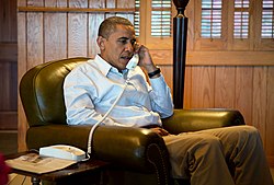 Obama on phone with FBI Director Robert Mueller and Chief of Staff Jack Lew to discuss the shooting on October 21, 2012. BarackObamaonphone.jpg